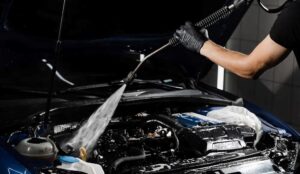 Can I use a pressure washer to clean my car engine?