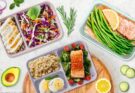 Meal prep containers with healthy food on a kitchen counter