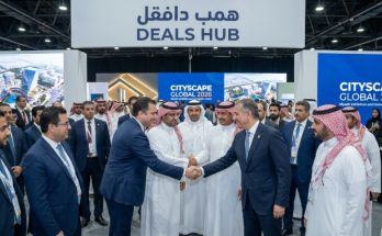 Investors and real estate developers shaking hands at the Deals Hub during Cityscape Global 2026 at Riyadh Exhibition and Convention Centre
