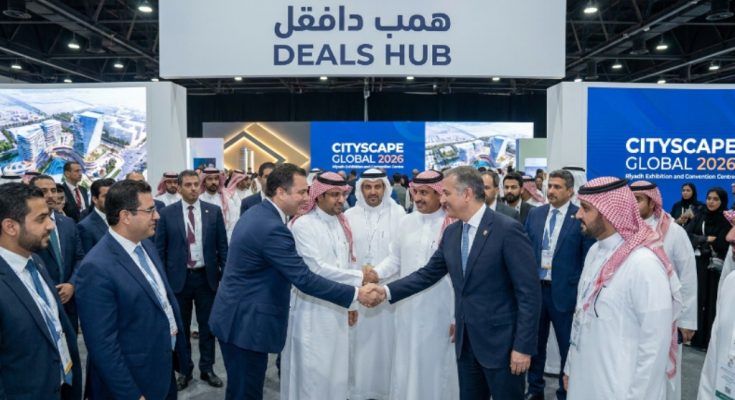 Investors and real estate developers shaking hands at the Deals Hub during Cityscape Global 2026 at Riyadh Exhibition and Convention Centre