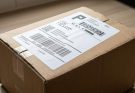 Removing a shipping label from a cardboard delivery box