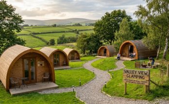 A scenic UK glamping site with wooden pods nestled in green countryside, representing the growing trend of Brits investing in camping land for income